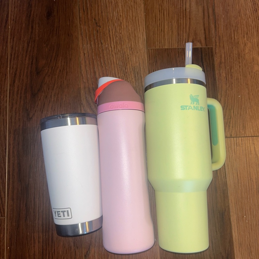 Stanley Green Tumbler, Pink Owala Bottle , and White Yeti Trio
